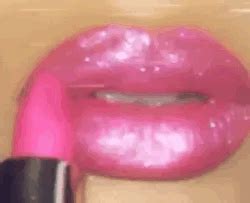 a close up of a pink lipstick with its mouth open