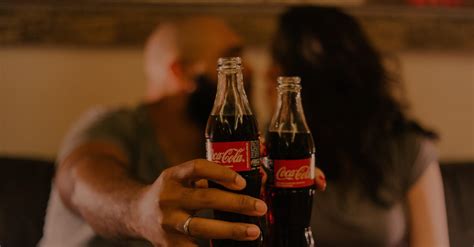 Close-Up Photography of People Holding Coca-Cola Bottles · Free Stock Photo