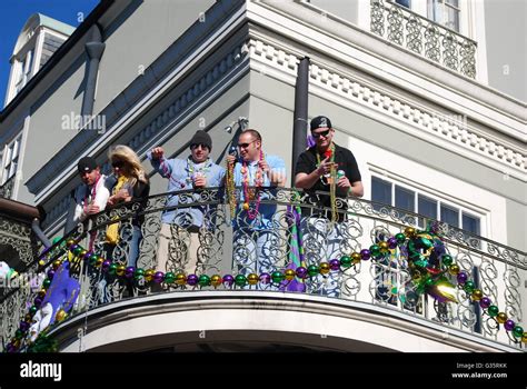 Mardi Gras revelers on a balcony on Bourbon St New Orleans Louisiana USA Stock Photo - Alamy