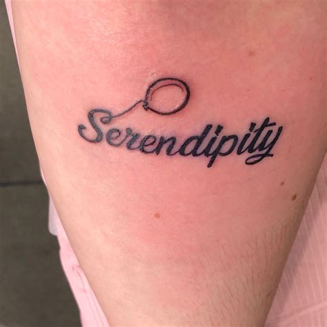 the word serendupity written in cursive writing on someone's leg