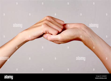 Female hands held upwards fingers interlocked together illustrating ...