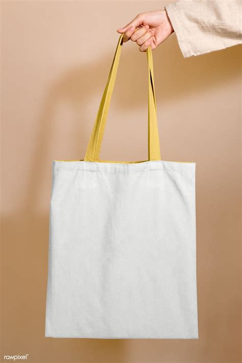 Download premium png of Woman holding a tote bag mockup in her hand by ...