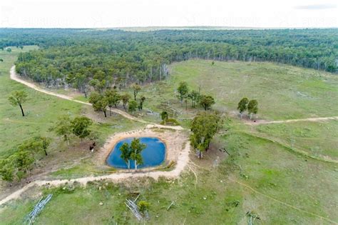 Image of Aerial view of a farm dam and paddock. - Austockphoto