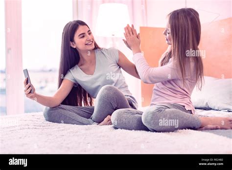 Cheerful friends giving high five to each other Stock Photo - Alamy