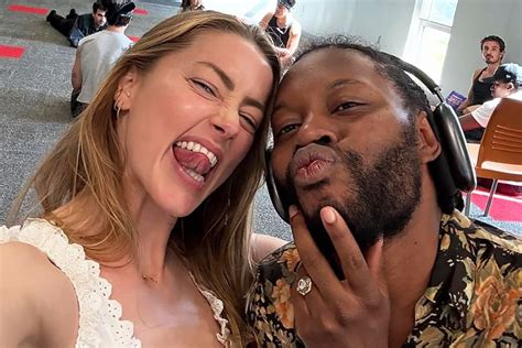 amber heard shares rare photo   returns  work   play
