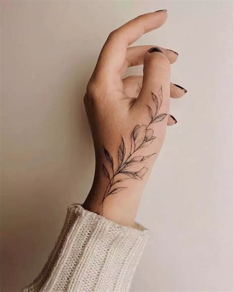 spellbinding flower hand tattoo ideas youll love