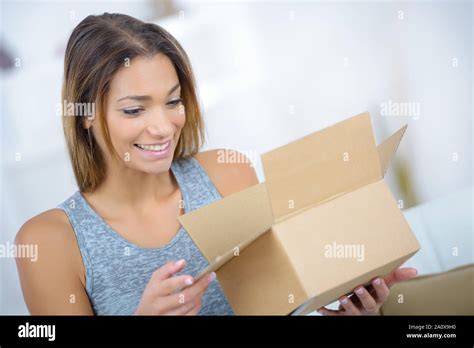 beautiful young woman opening box stock photo alamy