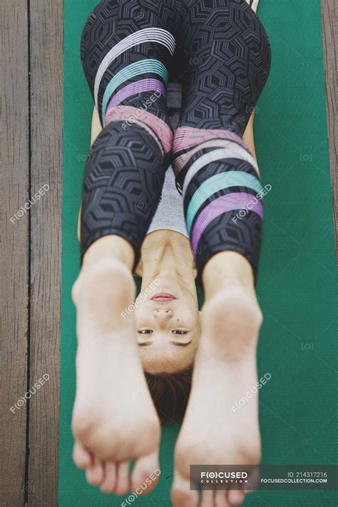Young sporty asian woman making yoga, top view — outdoors, fit - Stock