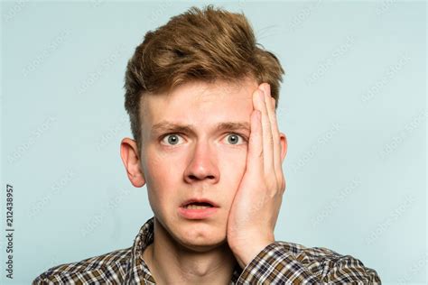 scared shocked terrified frightened startled man clutching hands