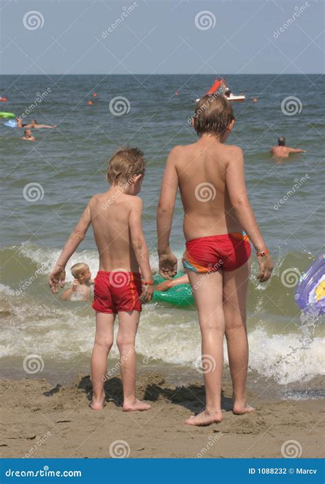 Two Boys At The Beach, Staring At The Sea Stock Photo - Image of coastline, coast: 1088232