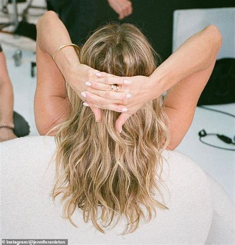 Jennifer Aniston shows off her natural curls while letting her hair ... 