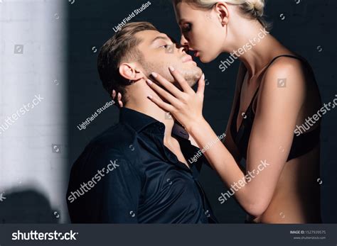 attractive woman black underwear kissing handsome stock photo