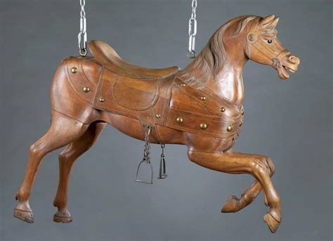 a wooden toy horse is hanging from chains