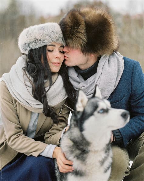 "Loving Couple With Dog In Winter" by Stocksy Contributor "Duet ...