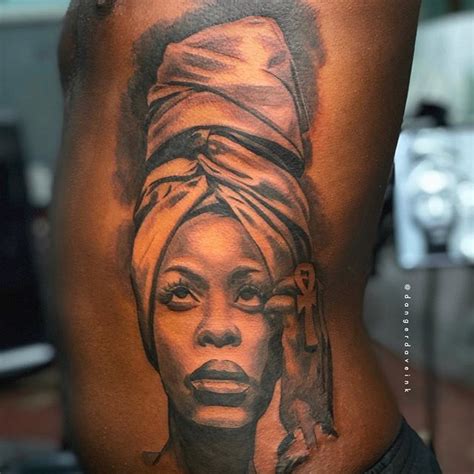 Erykah Badu Tattoos On Her Back