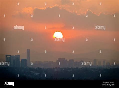 Mexico City,Lomas de Chapultepec,setting sun sunset clouds haze hazy ...