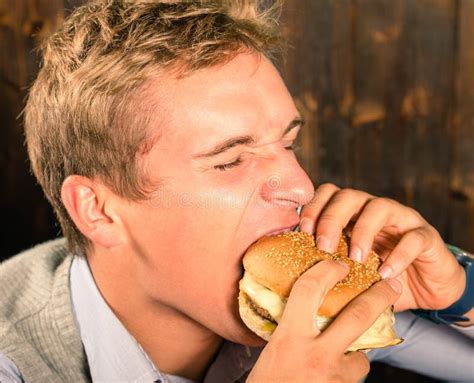 Handsome Man Eating Cheeseburger Royalty Free Stock Images - Image ...