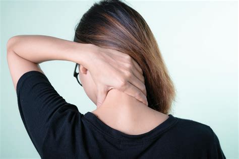 woman holding  neck  stock photo