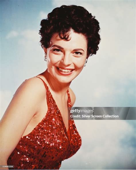 Anne Bancroft , US actress, smiling and wearing a red sequinned... News