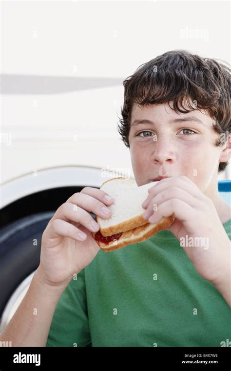 Boy eating peanut butter and jelly sandwich Stock Photo - Alamy