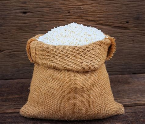 premium photo close   rice  sack  wooden table