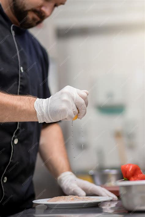 Premium Photo | Close up of professional chef preparing chicken meat on