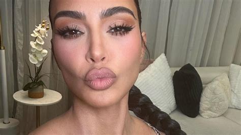 Kim Kardashian nearly pops out of tiny snakeskin bra and shows off her ...