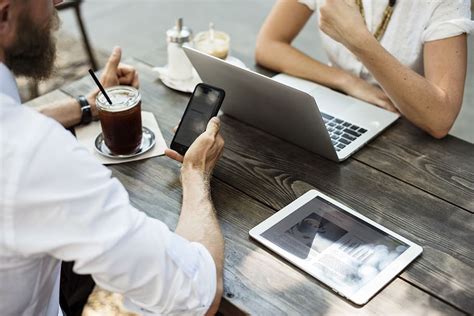 two, person, sitting, in-front, table, white, ipad, silver macbook