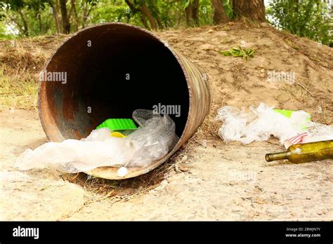 Sewer pipe with trash outdoors. Concept of soil pollution Stock Photo ...