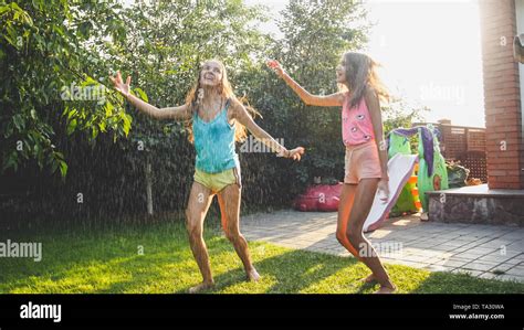 Sisters playing rain hi-res stock photography and images - Alamy