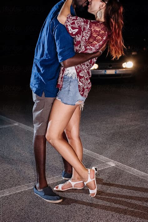 "Black Man And A White Woman Kissing On The Street" by Stocksy
