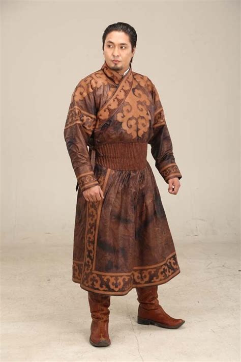 a man in a brown and black outfit is standing with his hands on his hips