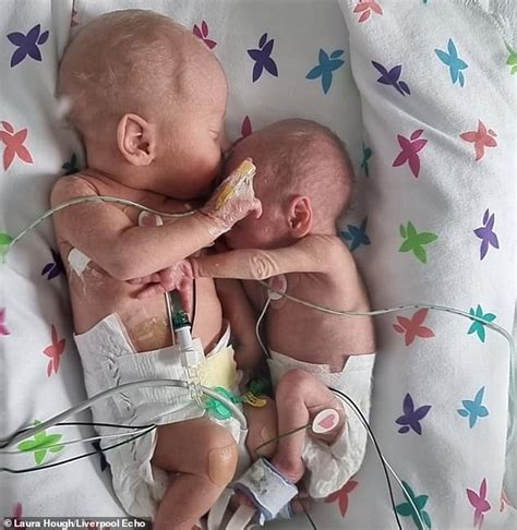 Premature twins separated at birth 'cuddle and hold hands'