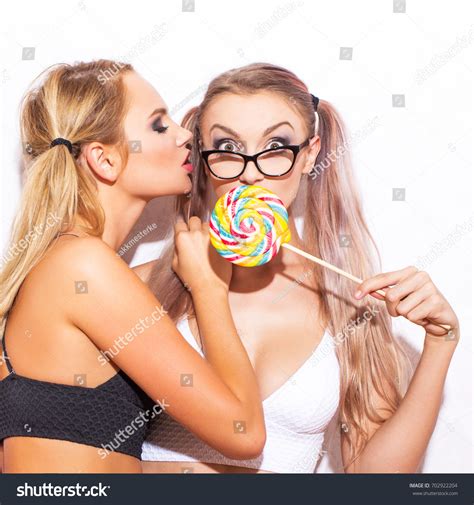 sexy blonde lesbian women playing lollipop stock photo