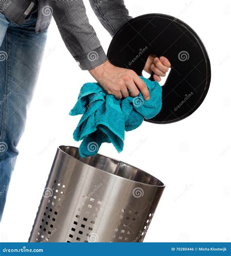 Young Man Putting a Dirty Towel in a Laundry Basket Stock Photo - Image