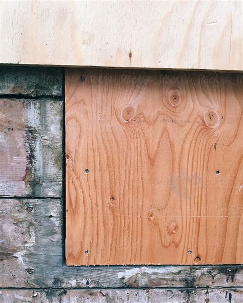 "Plywood Covering Old Wood Siding And Window On House Exterior" by