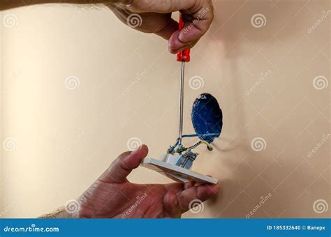Fixing light switch stock photo. Image of attaching - 185332640