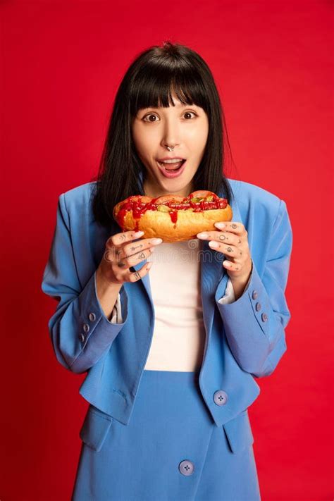 portrait  young girl  stylish blue costume posing eating spicy