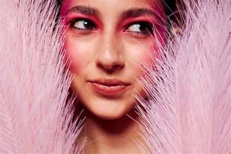 premium photo portrait  beautiful young woman pink feathers pink