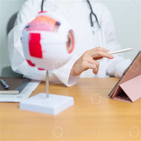 Doctor with human Eye anatomy model with magnifying glass. Eye disease
