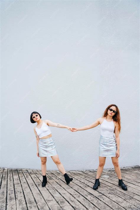 Premium Photo | Full length of lesbian couple holding hands standing