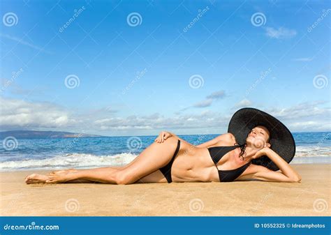 Woman sunbathing on beach stock image. Image of beach - 10552325