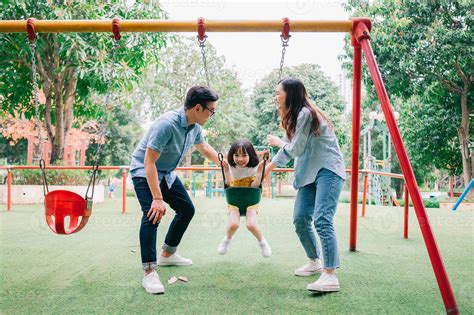 Image of young Asian family playing together at park 6907694 Stock