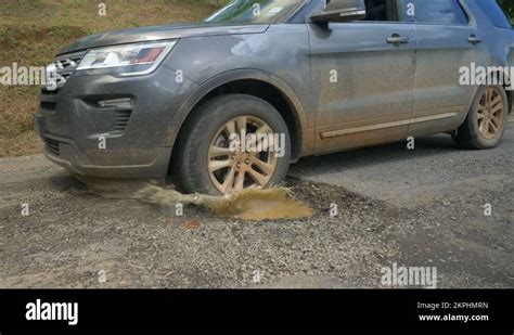 close  tourist suv drives   massive pothole gaping