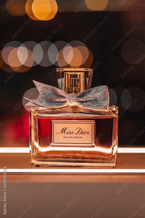 glass bottle   dior luxury perfume   stand  golden bokeh