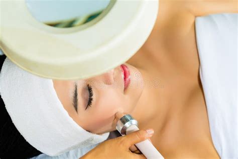 Asian Woman Getting a Facial Treatment in Spa Stock Photo - Image of ...