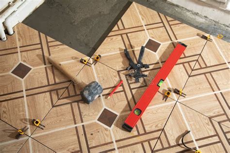 Laying Floor Ceramic Tile. Tools for Renovating Floor Stock Image ...