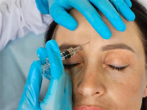 Premium Photo | Woman Receiving Forehead Botox Injection In Clinic