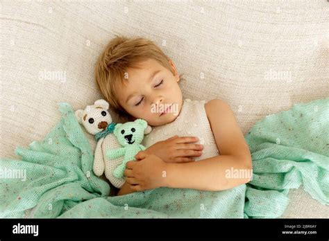 Little toddler child, cute kid with knitted small cute animal toy ...