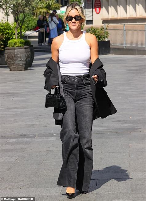 Ashley Roberts goes braless in a white tank top and frayed jeans as she